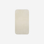 Top view of a beige organic cotton face towel with rounded corners, displayed flat on a white background.