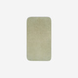 Top view of a light grey organic cotton face towel laid flat with rounded corners, shown on a white background.