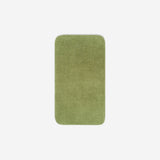 Top view of a green organic cotton face towel laid flat with rounded corners, shown on a white background.
