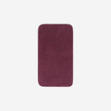 Top view of a purple organic cotton face towel with rounded corners, displayed flat on a white background.