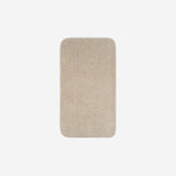 Top view of a light cream organic cotton face towel with rounded corners, displayed flat on a white background.