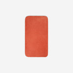 Top view of an orange organic cotton face towel with rounded corners, displayed flat on a white background.