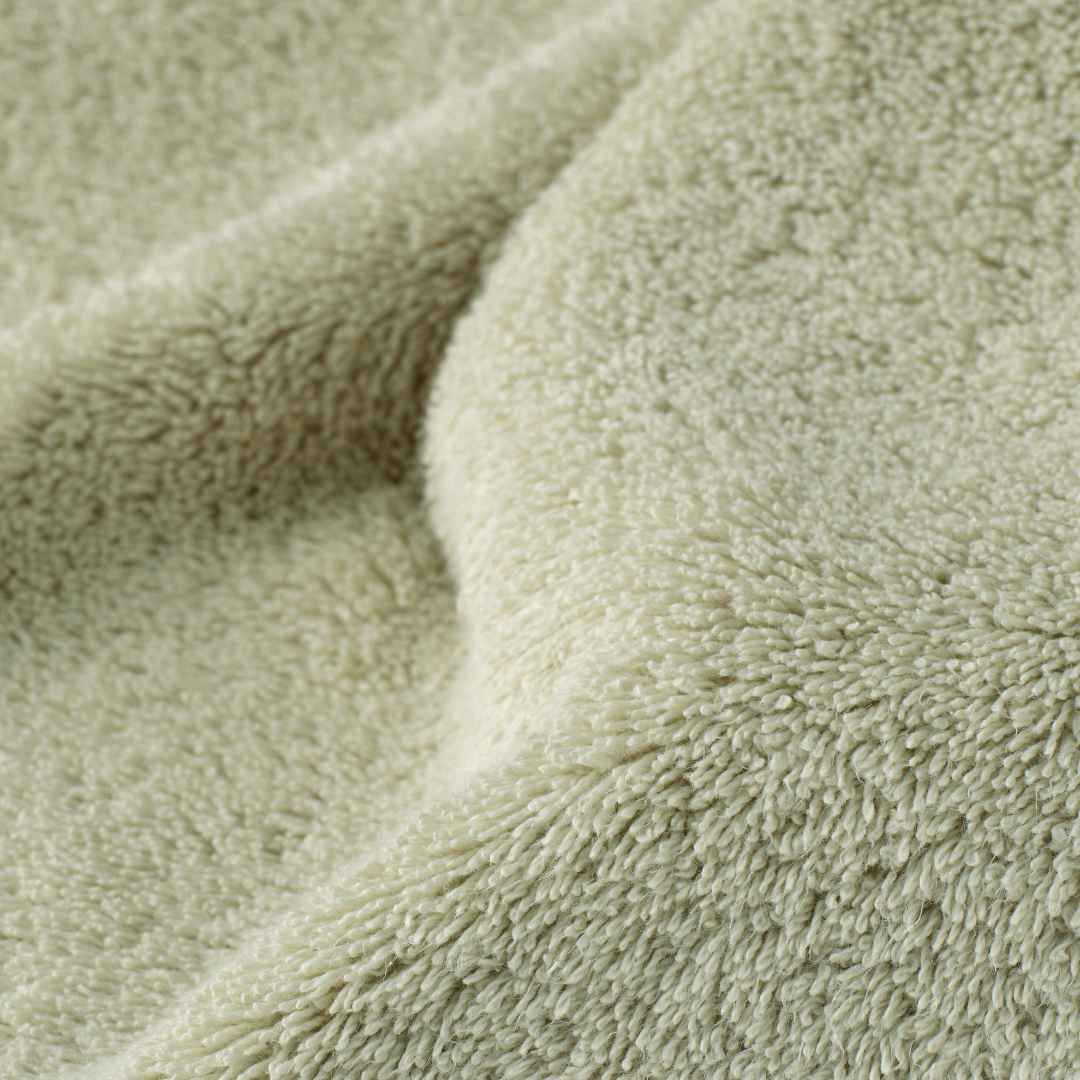 Close-up of a textured green fabric surface.