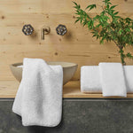 Bathroom with wooden wall, sink, and towels