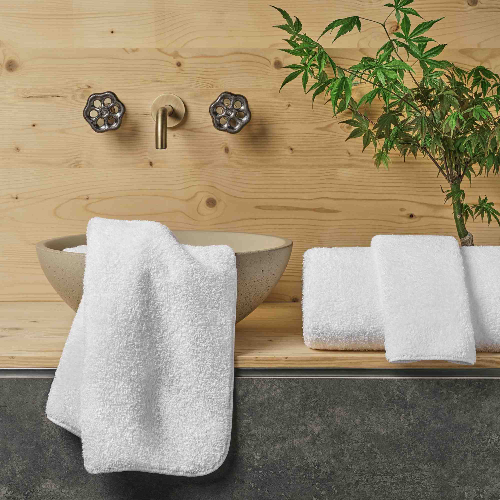 Bathroom with wooden wall, sink, and towels
